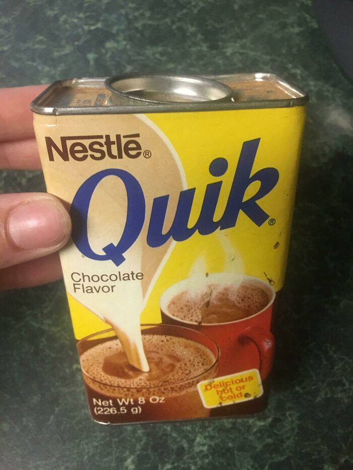 Vintage 90s Nestle Quik chocolate drink mix in a tin can, evoking nostalgic flavors from the past.