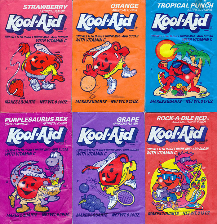 Assorted 90s Kool-Aid packets featuring nostalgic flavors like Strawberry, Orange, and Tropical Punch.