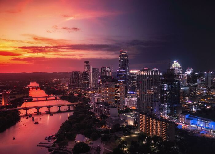 Stunning cityscape at sunset, showcasing incredible world photos with vibrant colors and illuminated buildings.