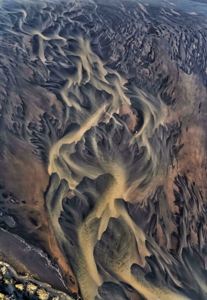 Aerial view of mesmerizing sand patterns, exemplifying incredible world photos with stunning natural textures.