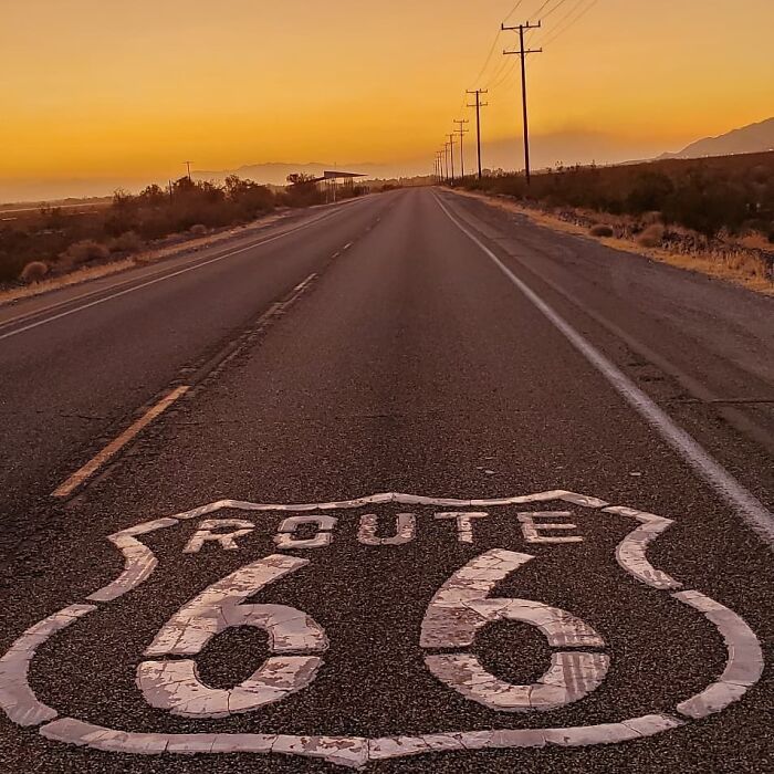 Route 66 at sunset, endless road stretching into the horizon, capturing an incredible world photo moment.