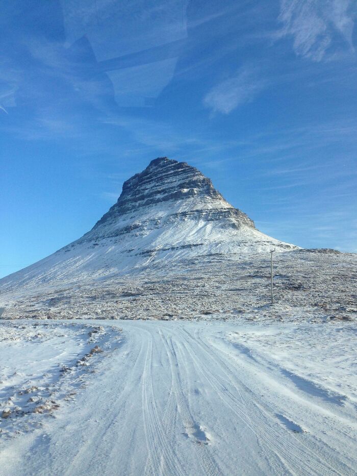 Snow-covered mountain under a clear blue sky, showcasing breathtaking scenery from incredible world photos.