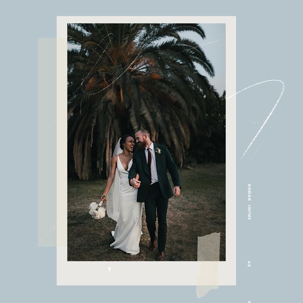 bride and groom holding hands and laughing in a tropical setting