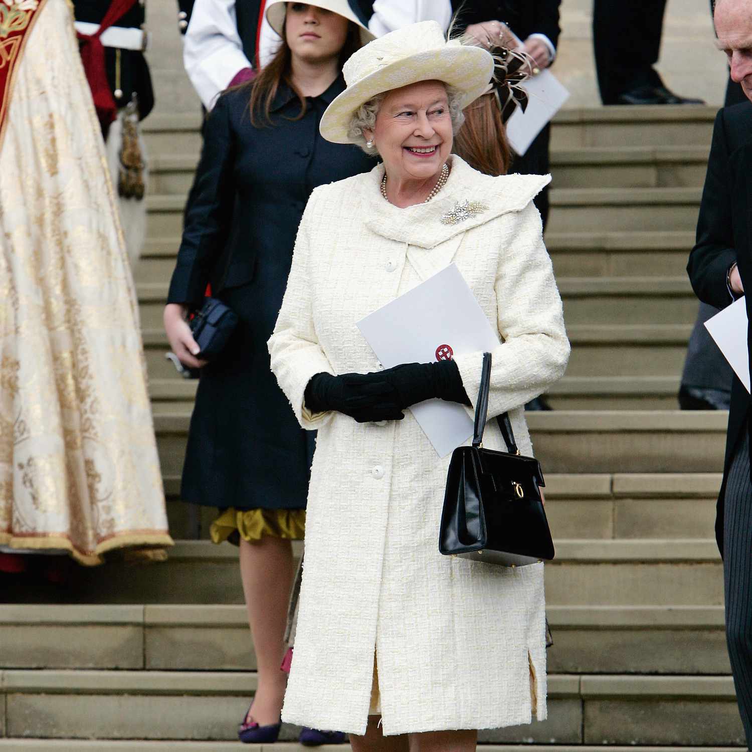 Queen Elizabeth Dressed in White Coat and Hat on Steps