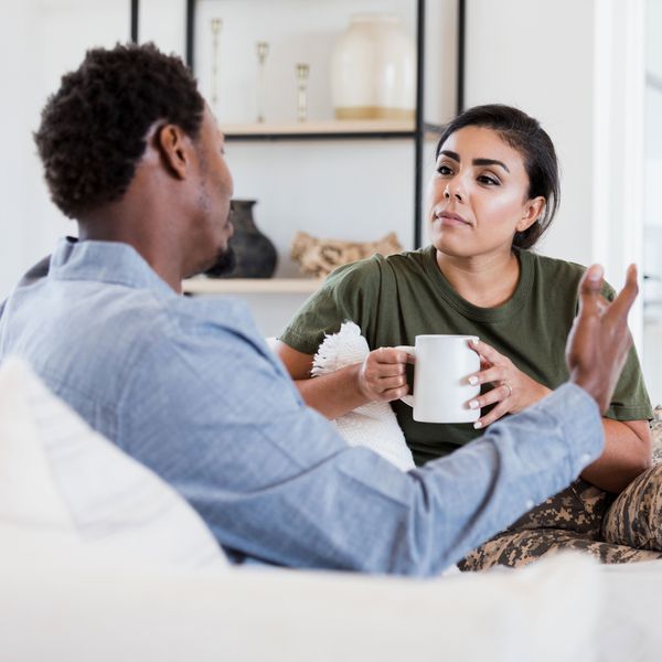 Man and Woman Sitting on Couch and Having a Serious Conversation