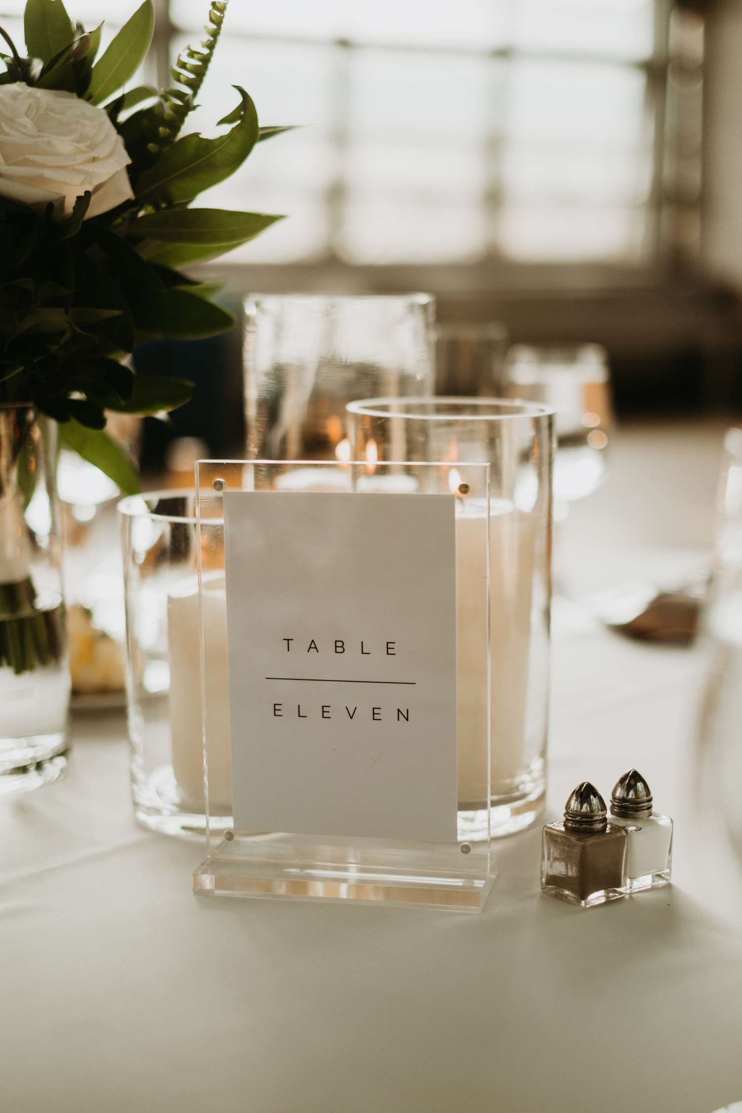 Black and white table number signs with candles