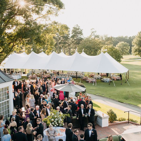 Wedding Reception Overview with Peak Tent and Guests Gathered on Patio