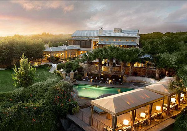 Aerial view of resort with palm trees and in-ground pool