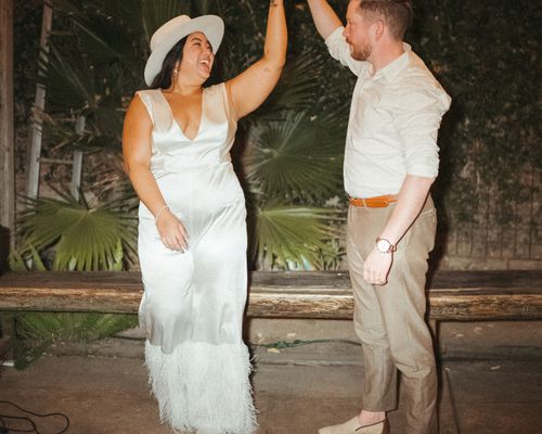 groom twirling a bride on the dance floor