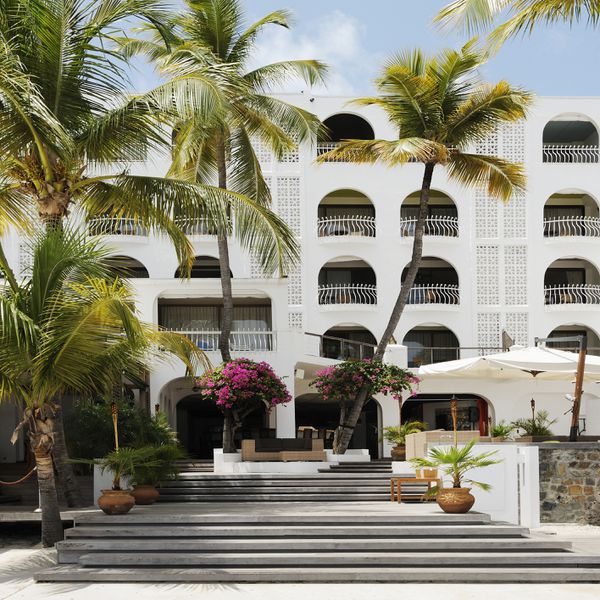 White resort hotel with palm trees