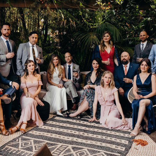 photo of bride and groom surrounded by a group of friends 