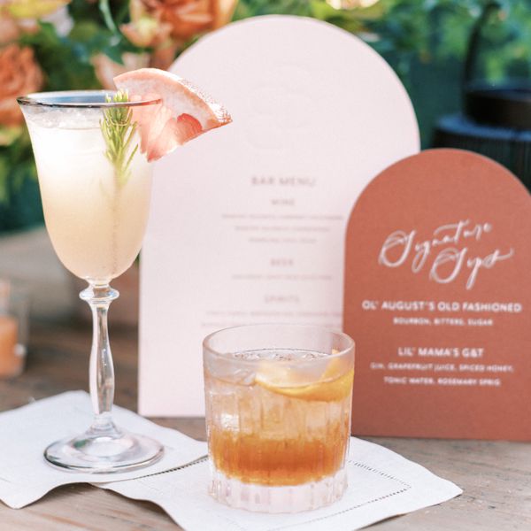 Signature cocktail with rosemary sprig and grapefruit and an old fashion