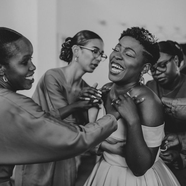 bride laughing and getting ready on wedding day