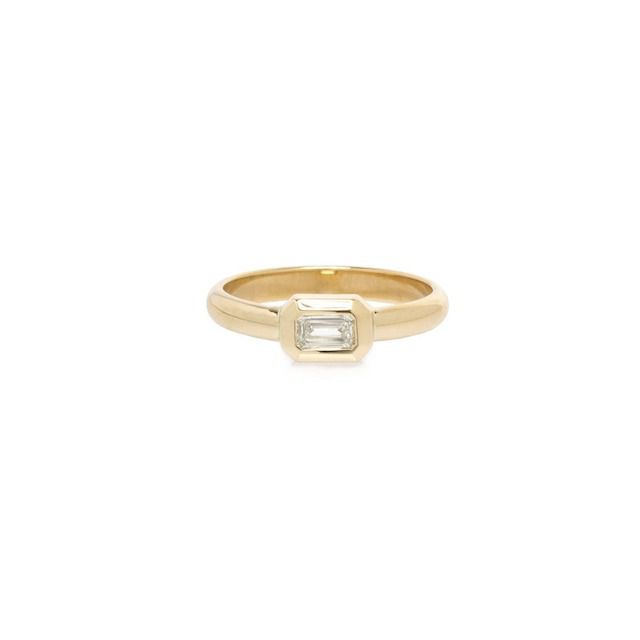 Small bezel set emerald cut engagement ring