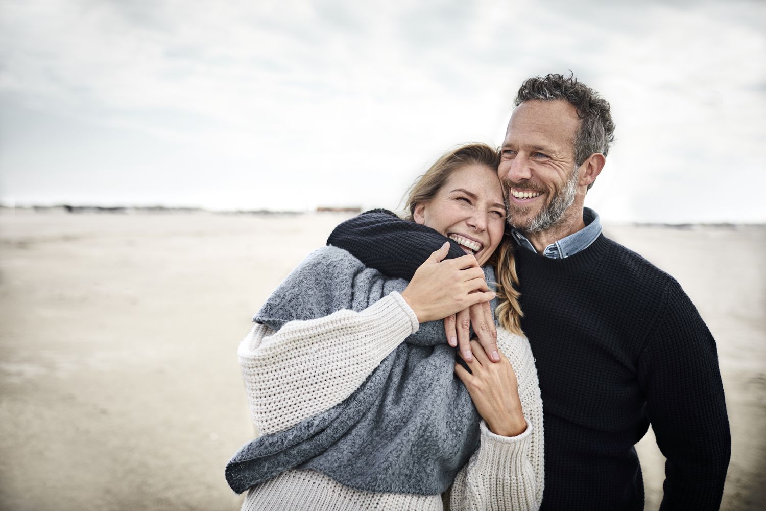 Closeup of a couple laughing on a beach