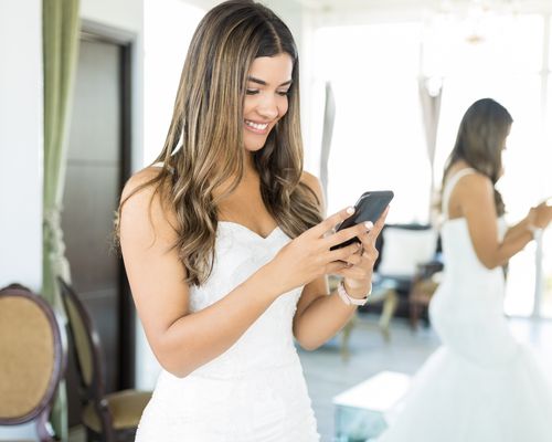 bride In Bridal Attire Holding Smartphone