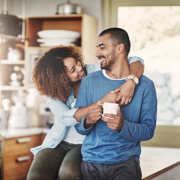 Shot of a happy young couple relaxing in the kitchen in the at home