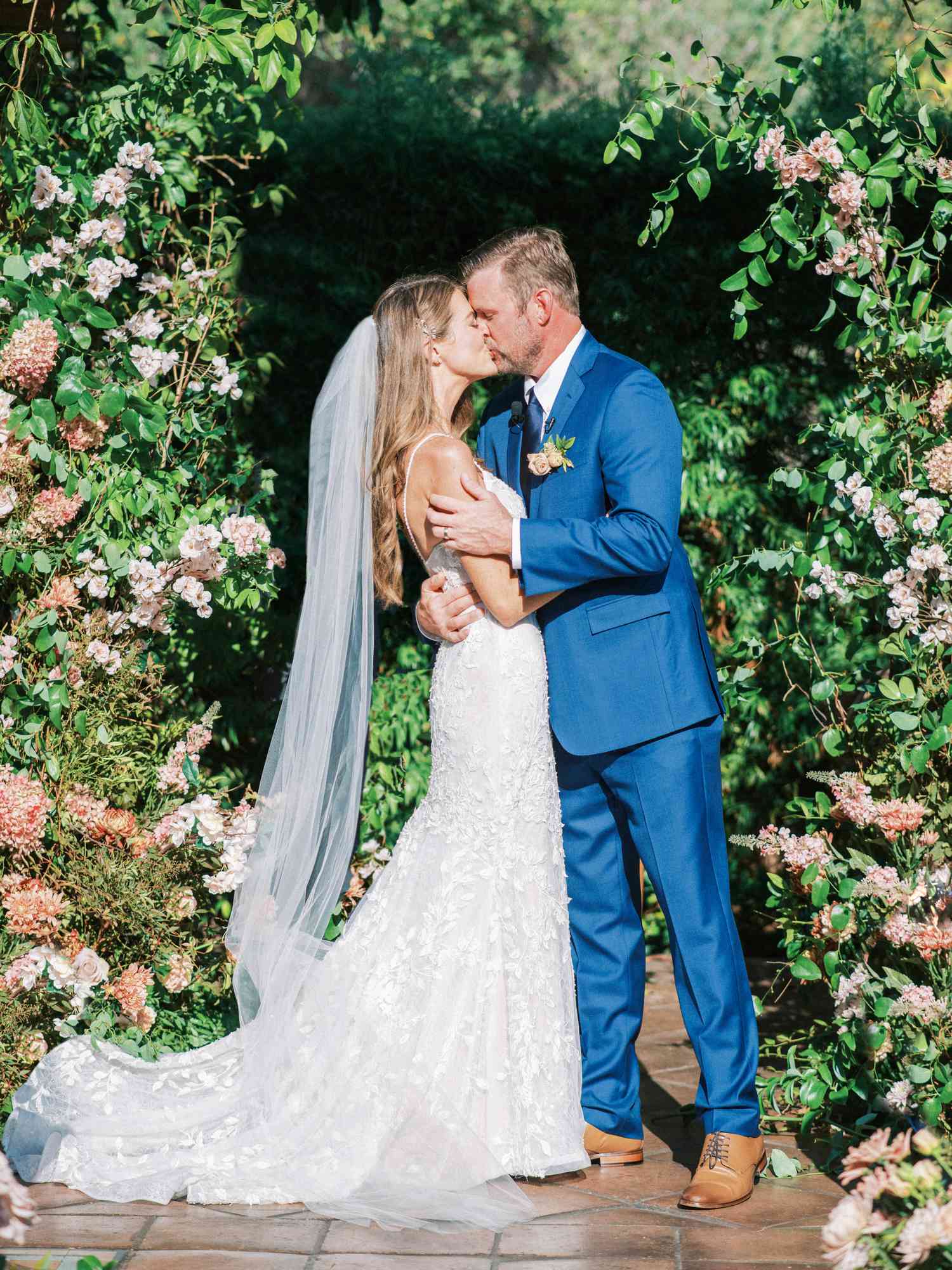 bride and groom kiss at altar