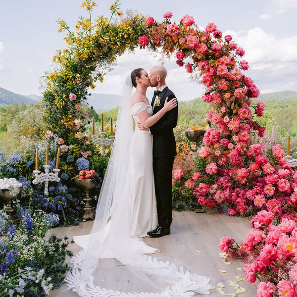 Wedding Couple Kissing By Flower Arch