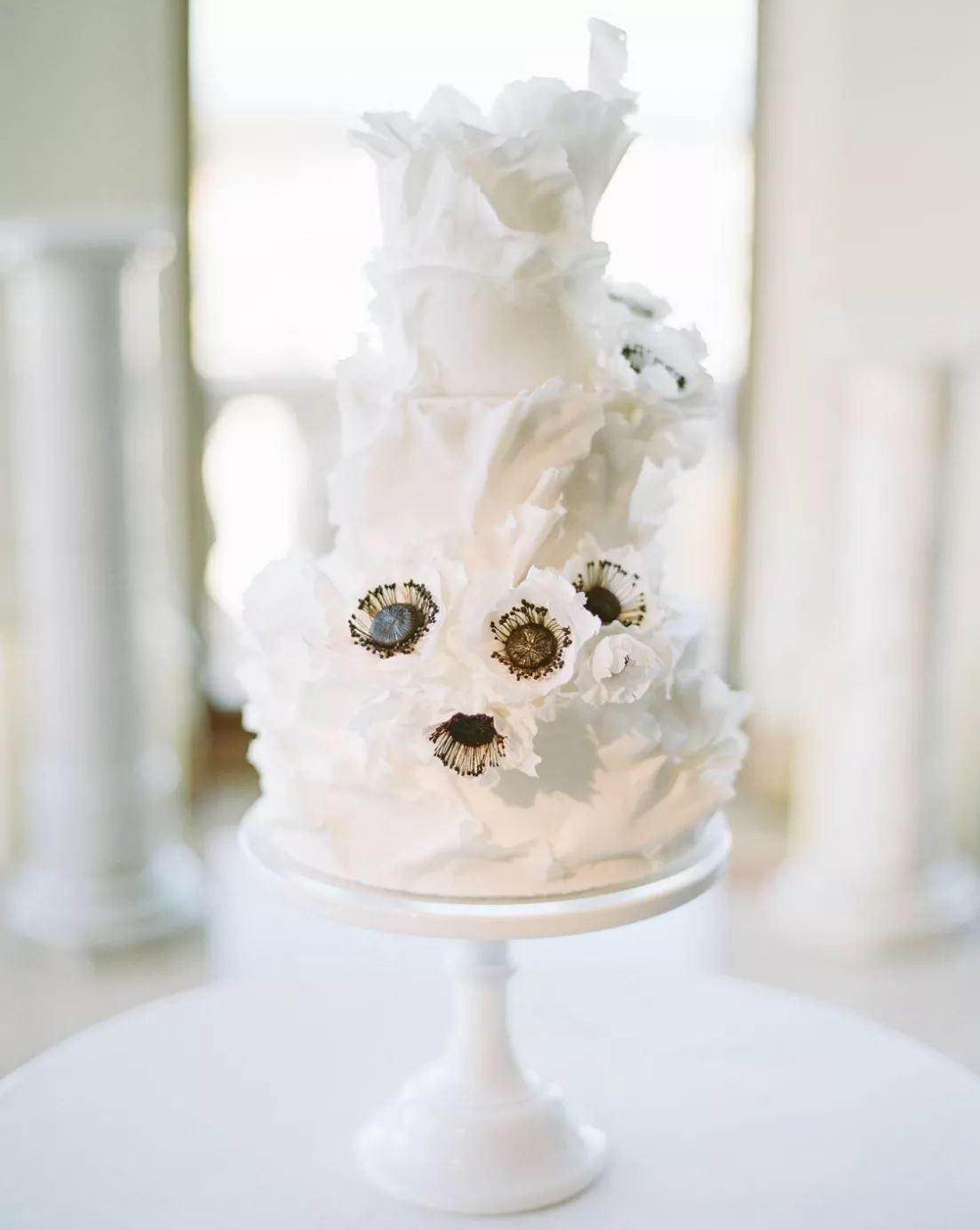 white wedding cake with black flowers