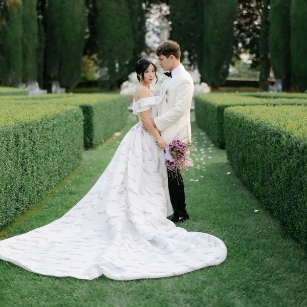 bride and groom posing in a grass maze