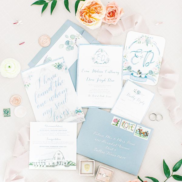 flat lay of a wedding invitation suite with a light blue colorway