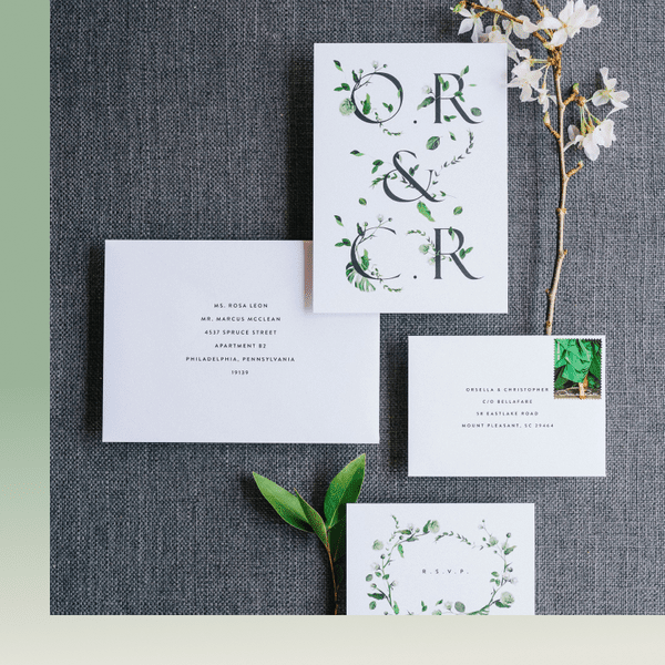 minimalist wedding invitation suite with greenery illustrations on front and RSVP cards