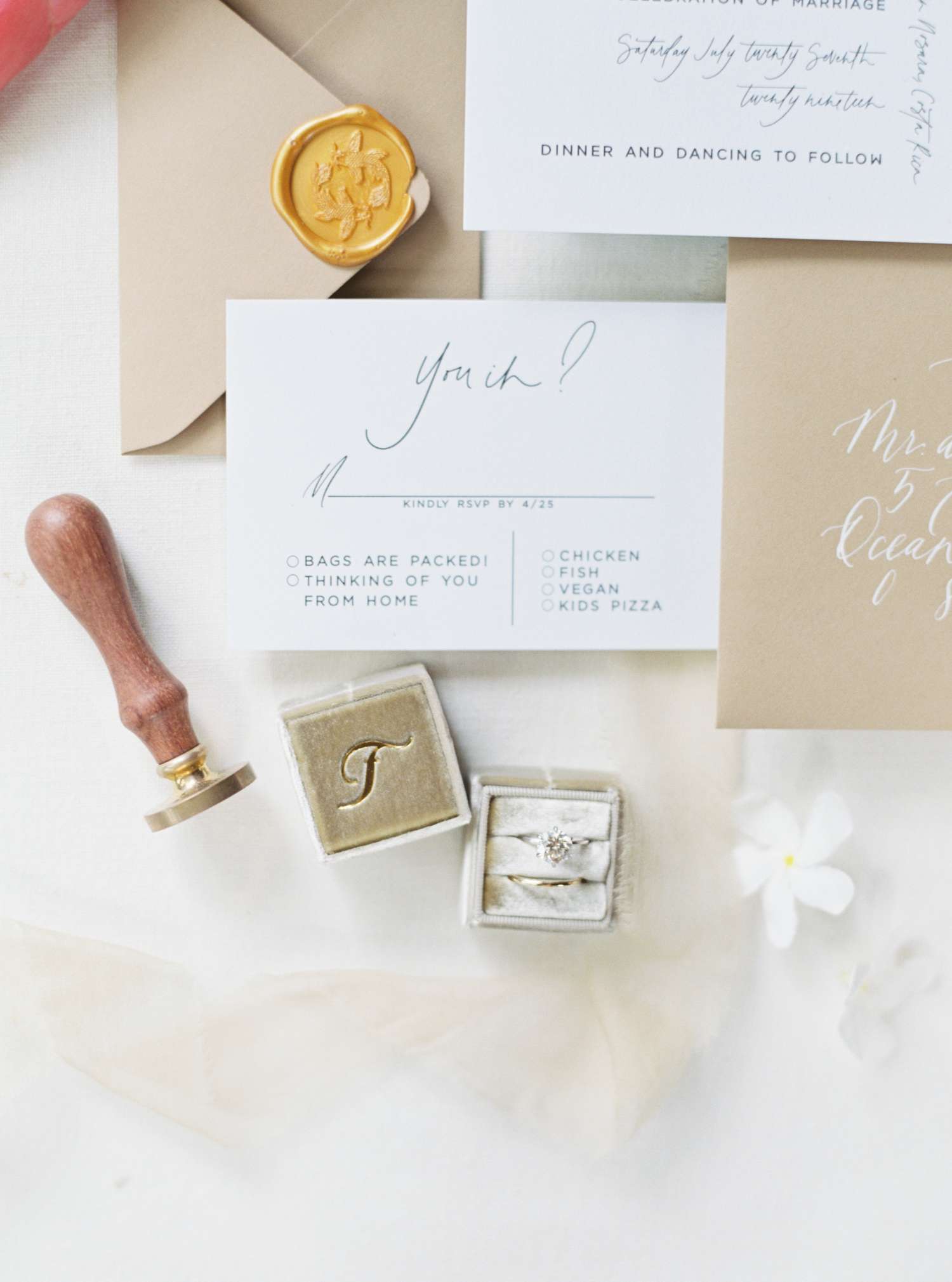 Response card flat lay with other wedding invitation elements