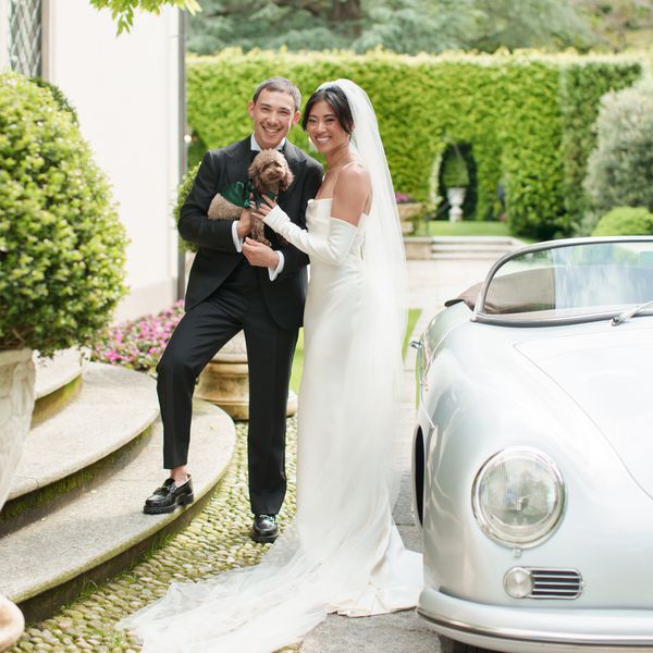 Influencer Christine Le in White Sheath Wedding Dress With Veil and Gloves With Husband and Dog in Front of Porsche