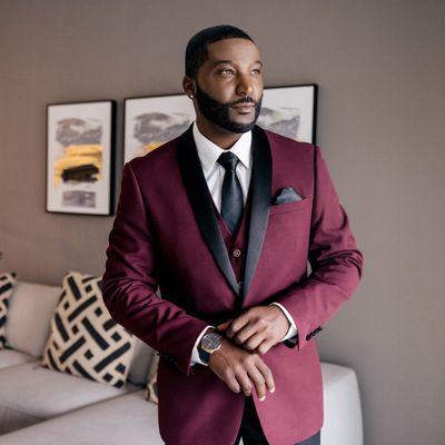 Groom in Burgundy Tuxedo with Black Lapels and Black Tie