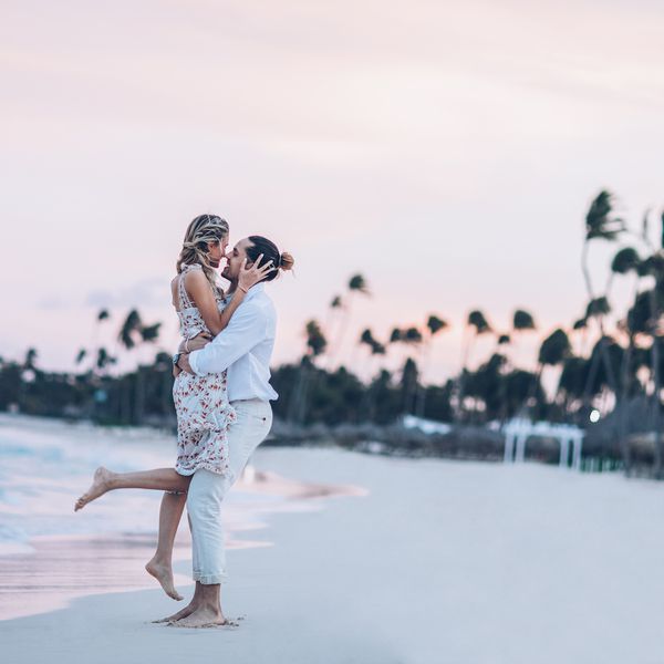 A couple kissing on the beach during sunset 