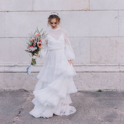 bride wearing a tulle wedding dress, holding a wildflower wedding bouquet 