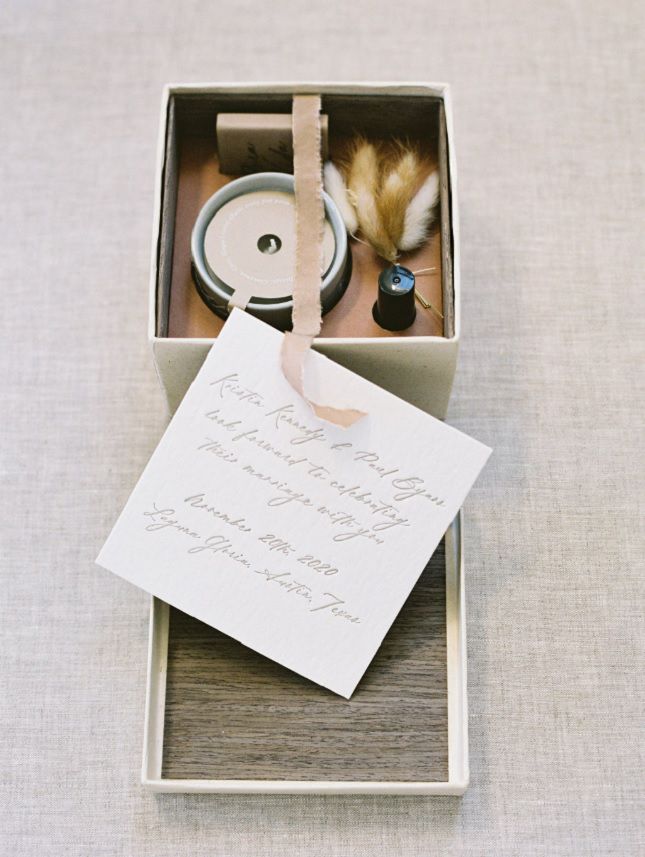 A wedding invitation box with a candle for guests.