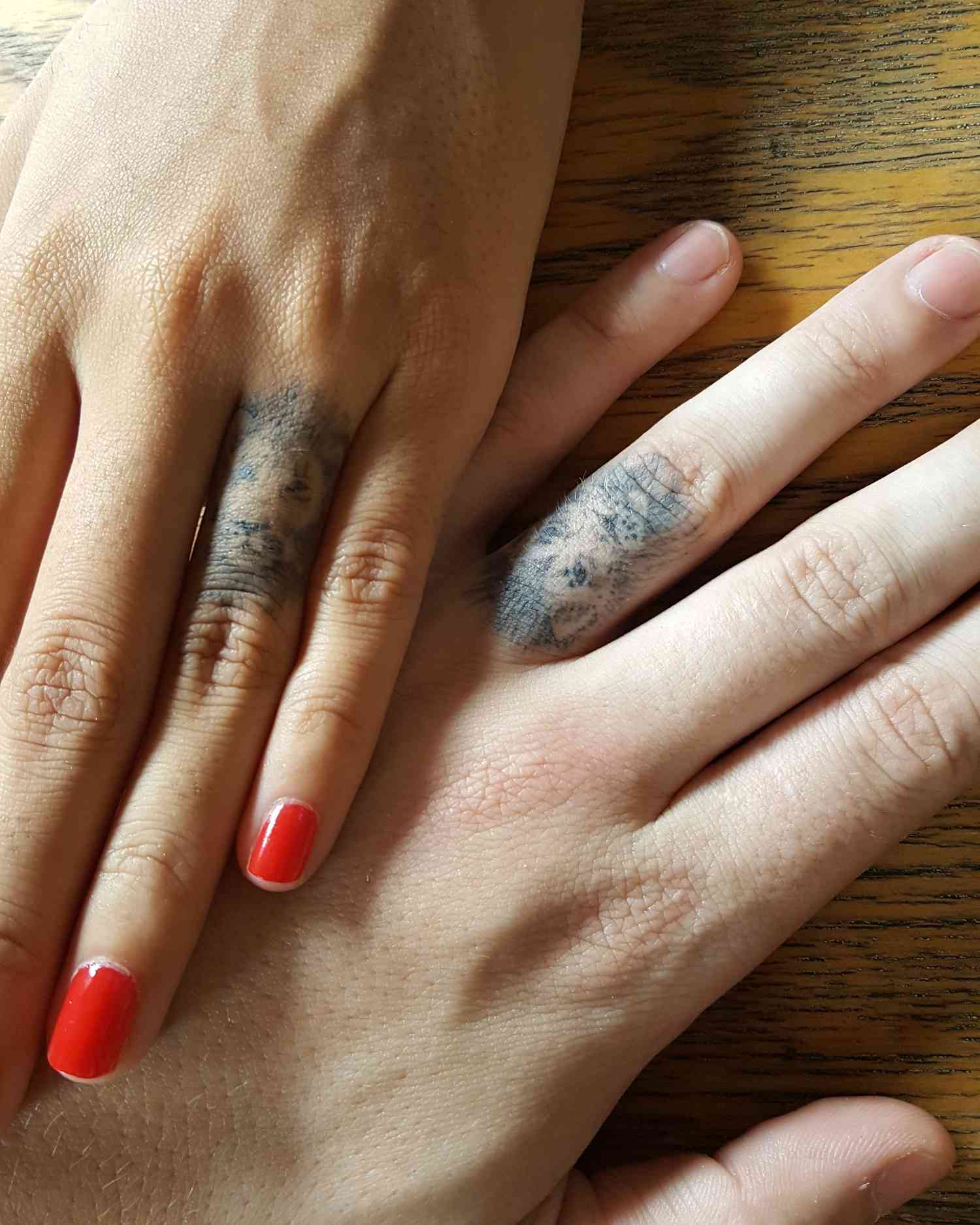 Wedding ring tattoos of two lions