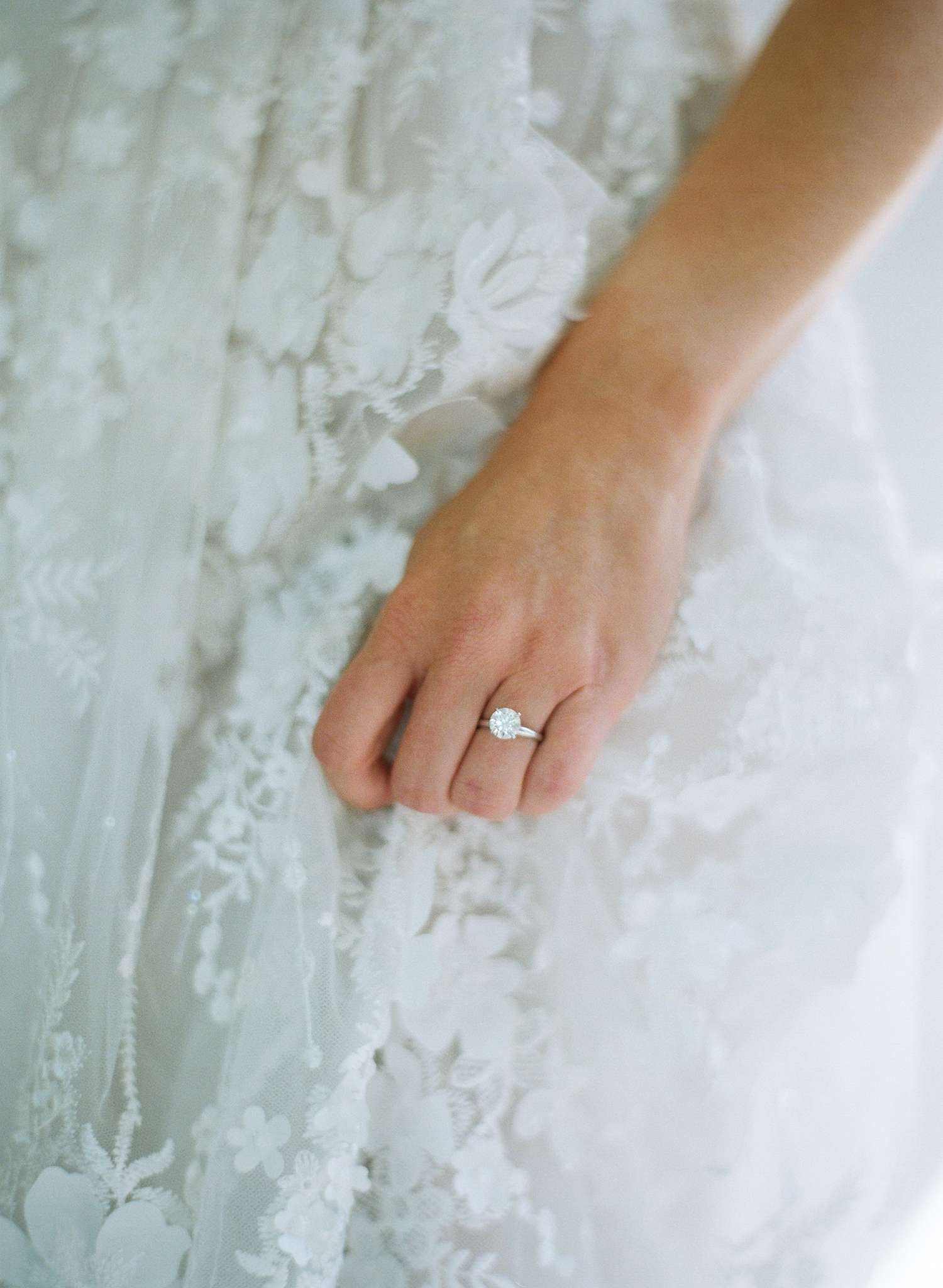 Bride wearing round-cut solitaire engagement ring