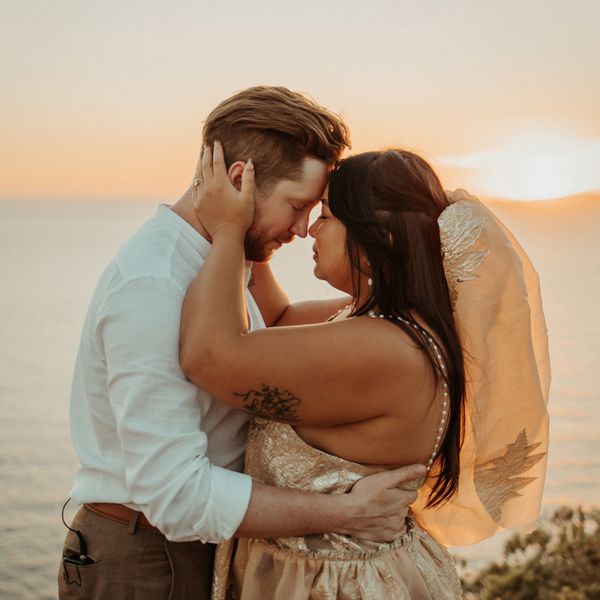 bride and groom embracing during golden hour