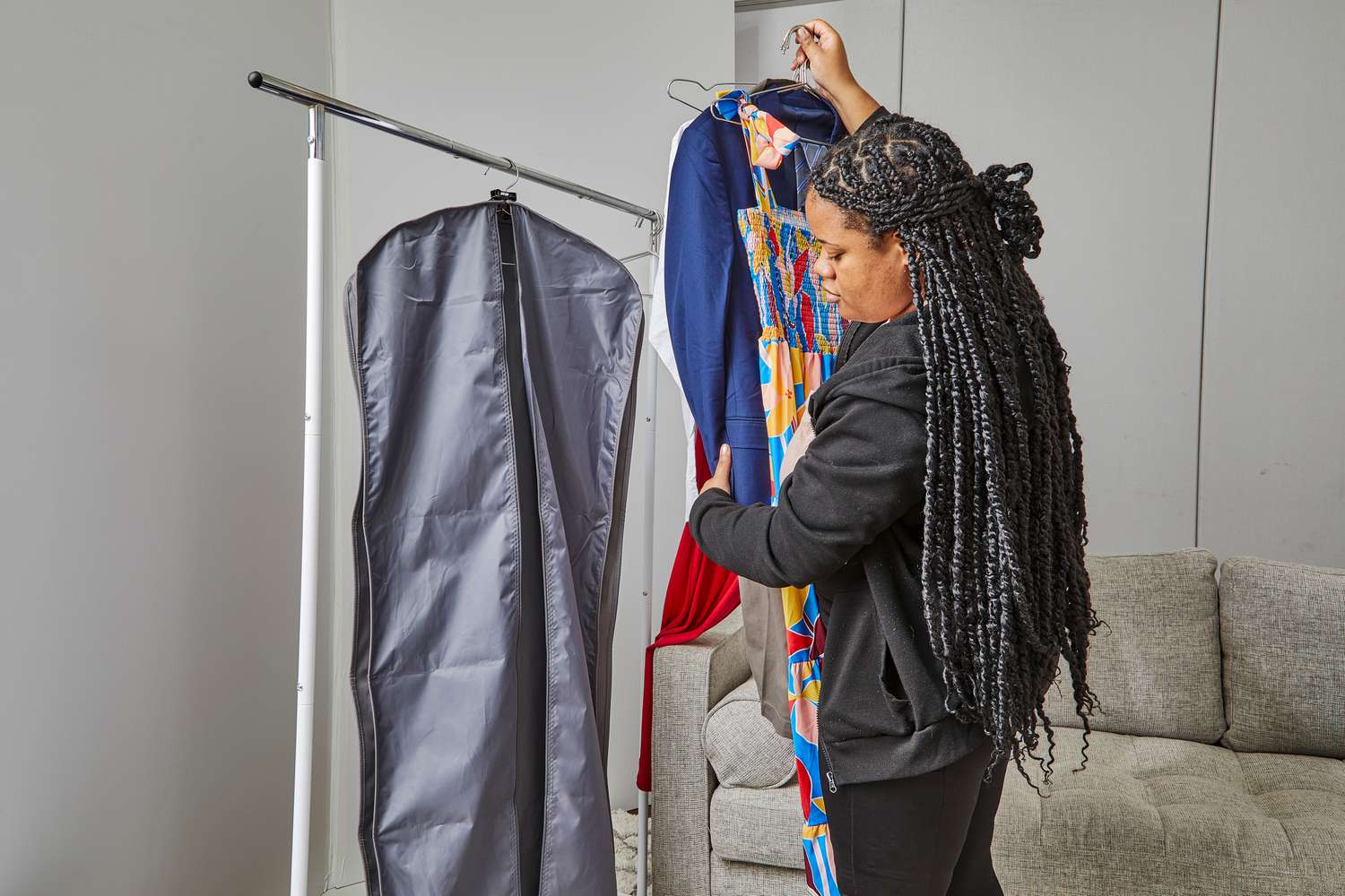 A person holding clothing next to the WallyBags Deluxe Garment Bag