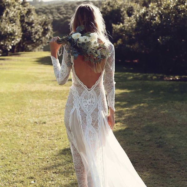 Bride in an open-back dress with a bouquet of flowers