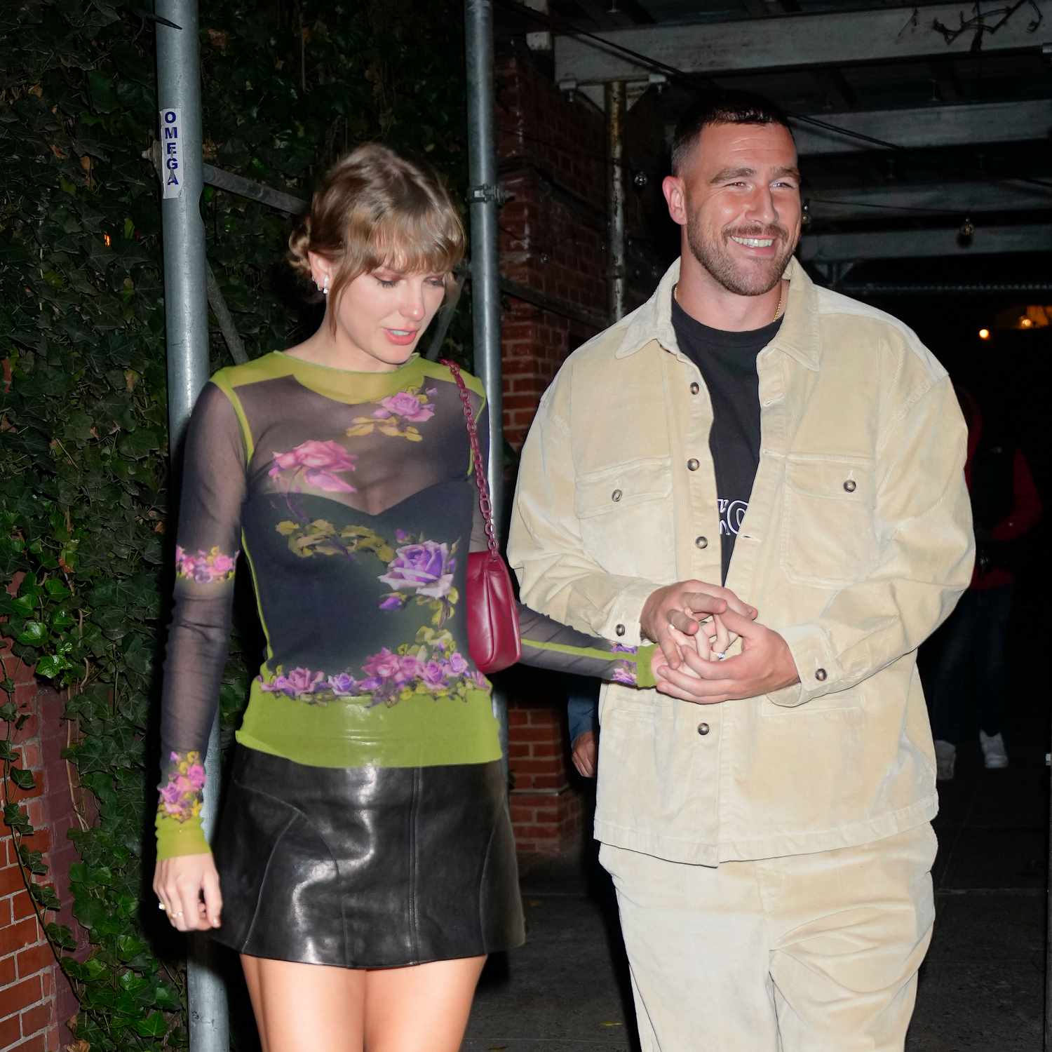 Taylor Swift and Travis Kelce holding hands