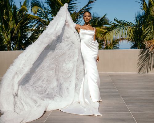 bride wearing a silk wedding dress and cape