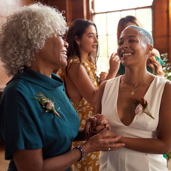 bride and mom with curly gray hair on wedding day