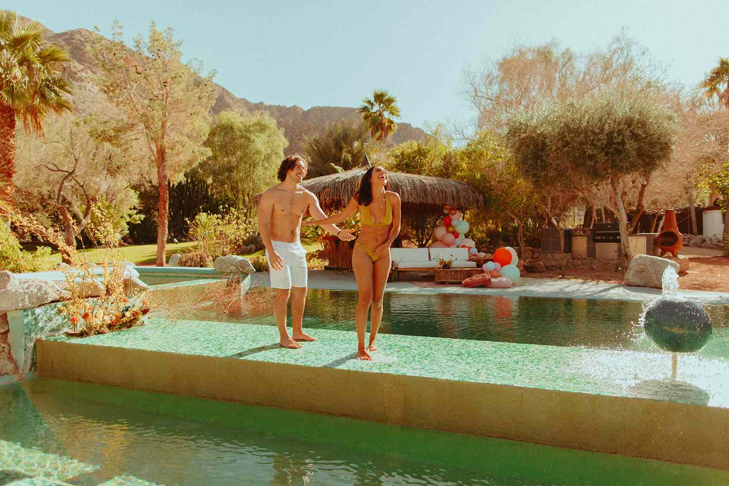 Couple walking by pool