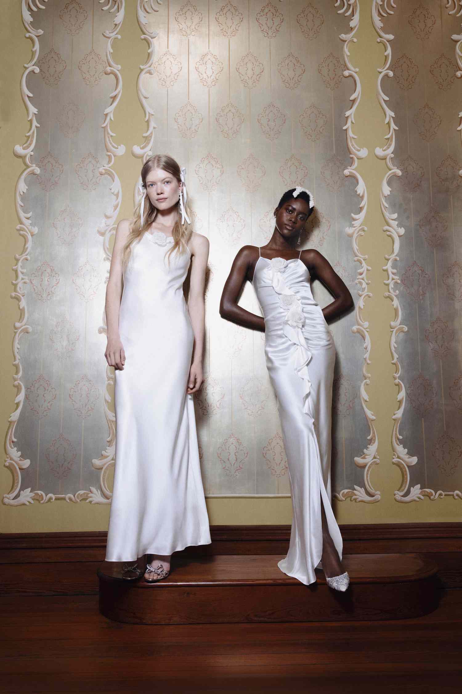 two models wearing white slip wedding dresses