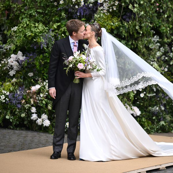 Duke of Westminster Hugh Grosvenor in Morning Dress and Dutchess of Westminster Olivia Henson in Long-Sleeved Wedding Dress With Embroidered Veil Kiss in Front of Church