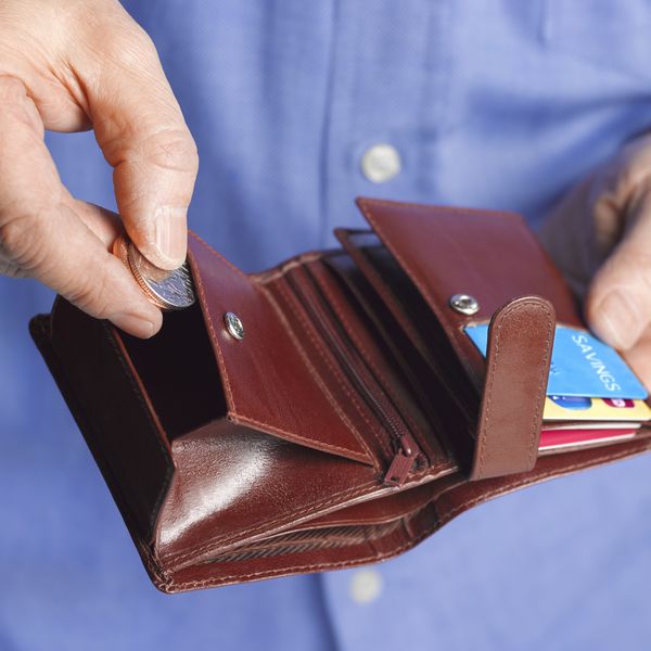 Mn Opening Brown Leather Wallet and Putting a Coin Inside