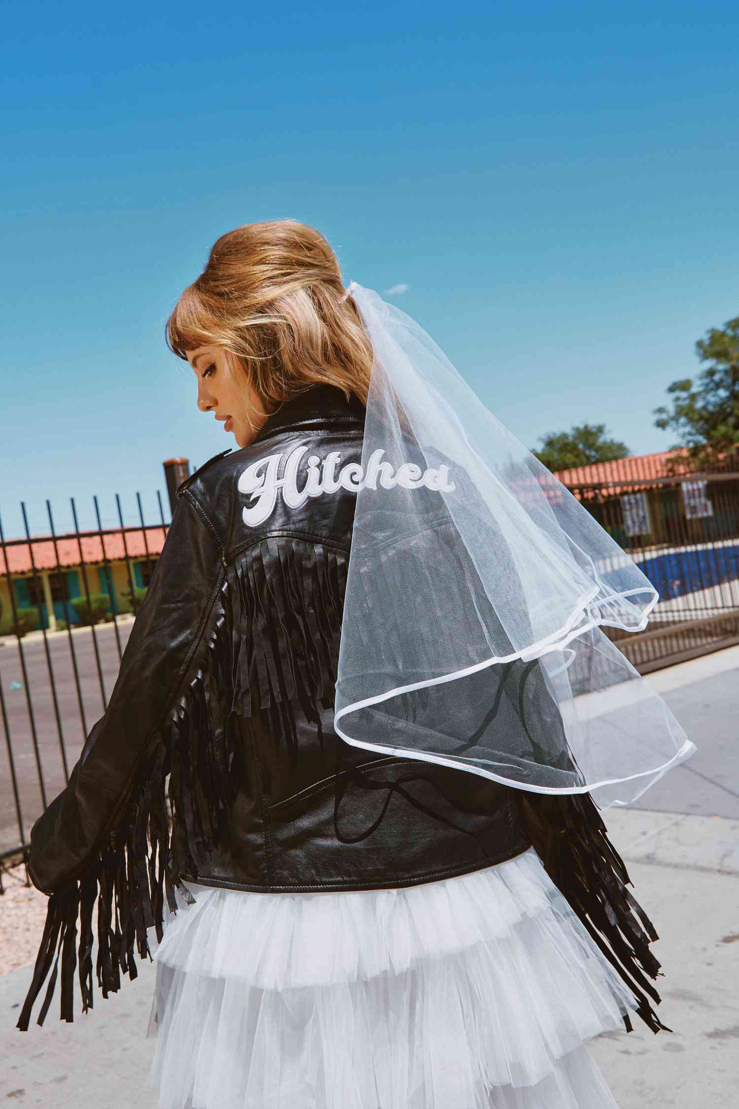 bride in leather jacket and mini tulle wedding dress