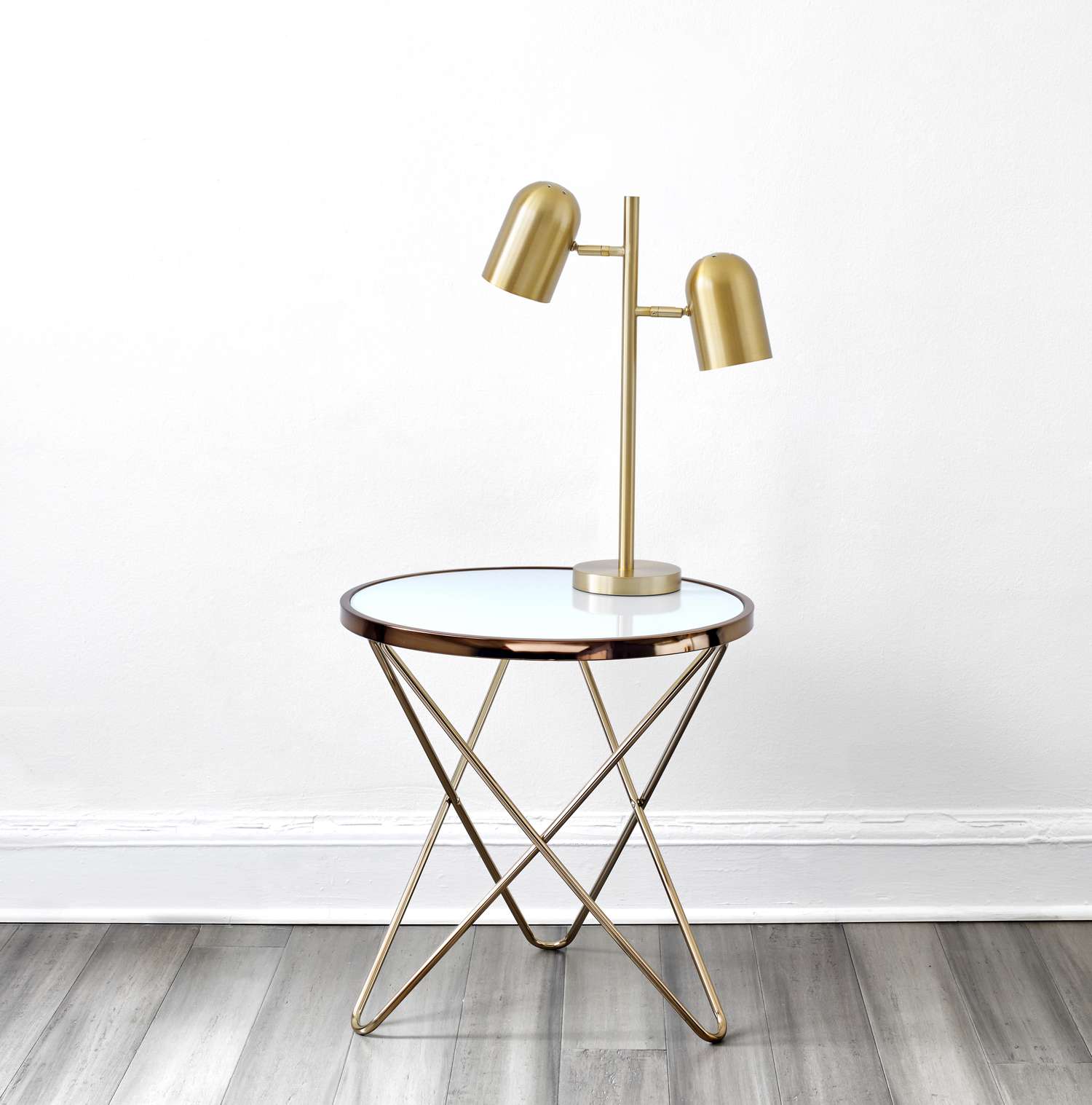 A bronze light fixture placed on a side table in a living room 