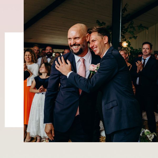 Wedding Ceremony with Two Grooms in Navy Suits Exchanging Rings