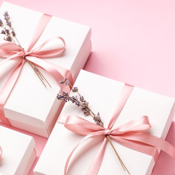 White Gift Boxes Wrapped with Pink Ribbon and Fresh Lavender Sprig