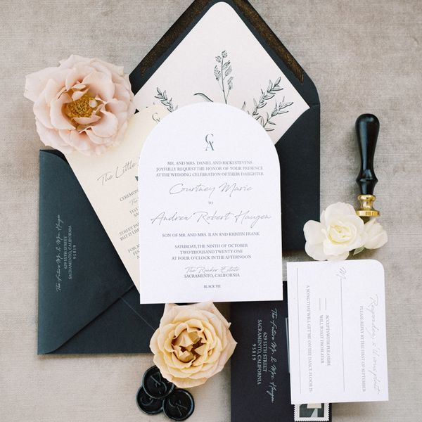 flat lay of invitation suite with black and white colorway